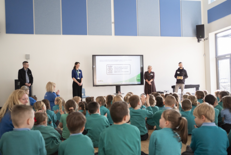 Announcing B Corp Certification in School Assembly iCT4 Staff presenting to children at Sky Primary and Eden Project Nursery